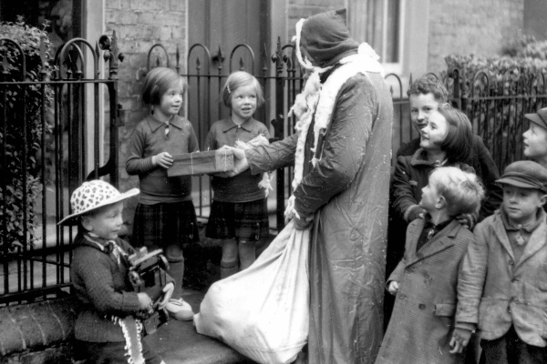 Living Magazines Father Christmas distributing gifts to the evacuees in Albert Street Tring in 1939