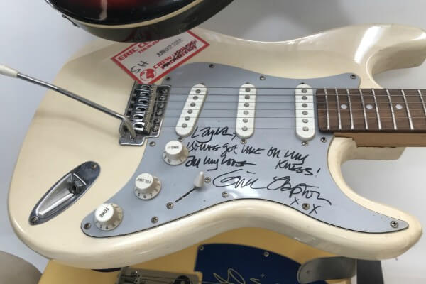 Living Magazines Rock Memorabilia Guitar signed by Eric Clapton