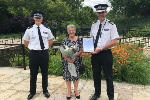 Living Magazines Herts Watch chair Sue Thompson receiving commendation from Chief Constable Charlie Hall