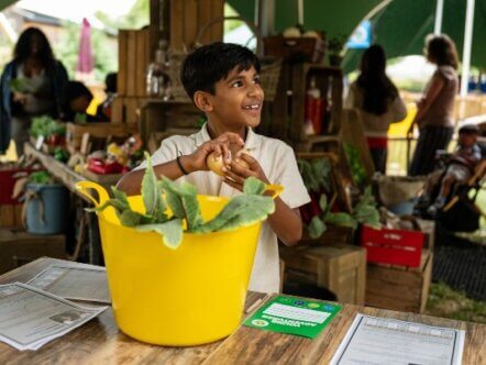 Kid role-plays as an animal nutritionist as part of the Zoo Crew (c) ZSL