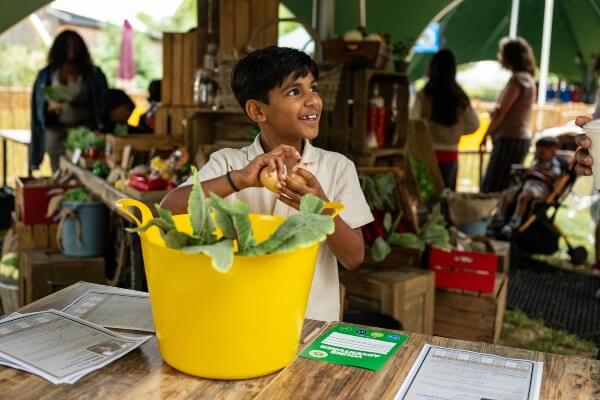 Kid role-plays as an animal nutritionist as part of the Zoo Crew (c) ZSL