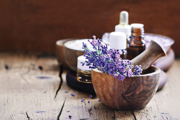 Lavender spa , bunch of lavender flowers , essential oil and salt on a rustic wooden background.