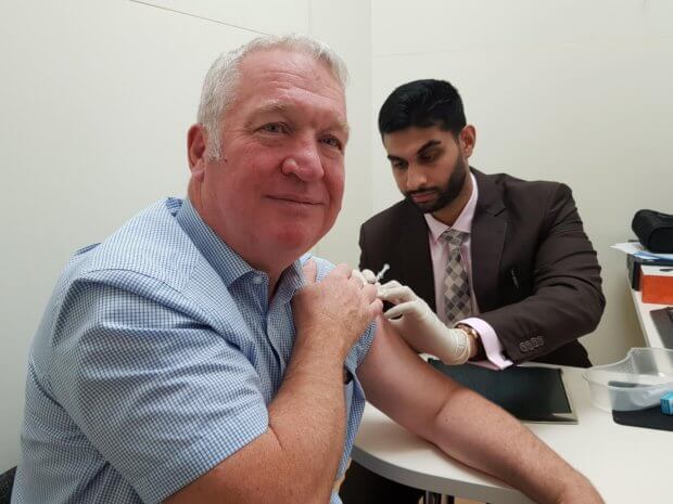 Living Magazines Sir Mike Penning MP receiving his flu jab