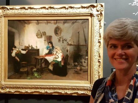 Living Magazines Melanie Czapski, Bucks County Museum Curator of Art, with 'A Scene from the Risorgimento’ by Italian artist Gerolamo Induno