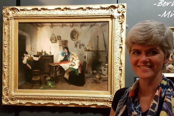 Living Magazines Melanie Czapski, Bucks County Museum Curator of Art, with 'A Scene from the Risorgimento’ by Italian artist Gerolamo Induno