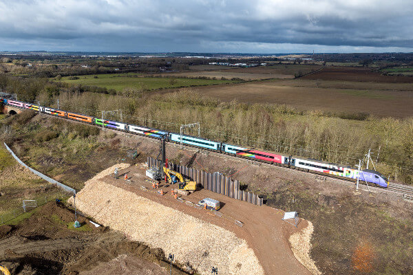 Living Magazines Network Rail Blisworth earthworks drone shot with Avanti Progress Train passing by