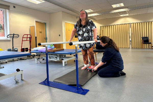 Penny Munro being supported by Lucy Sharpe, one of the physios at the Chilterns Neuro Centre