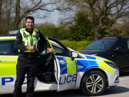 Living Magazines Police Ride Along Scheme Kash in front of car
