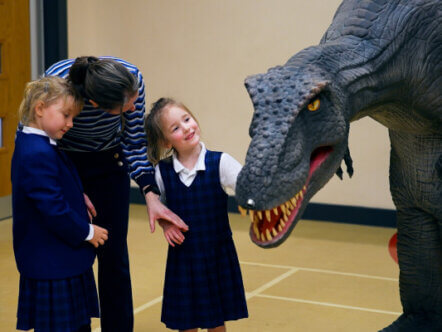 Primary school pupils meet Reggie the T-Rex