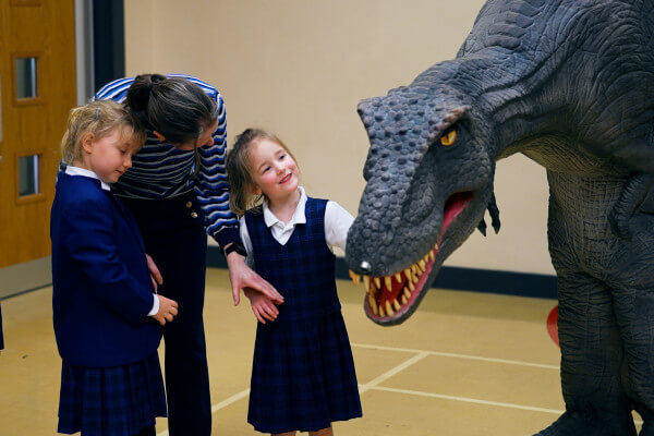 Primary school pupils meet Reggie the T-Rex