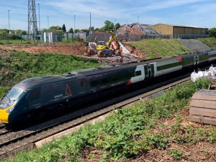Railway Platinum Jubilee Avanti West Coast train passing through cutting near Penkridge
