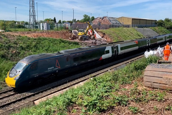 Railway Platinum Jubilee Avanti West Coast train passing through cutting near Penkridge