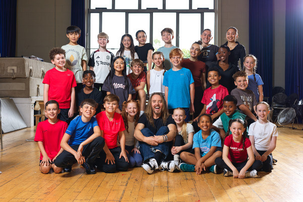 Tim Minchin with the Young Tour Cast of Matilda the Musical, 2025 by Phil Tragen