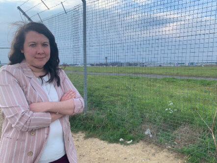Victoria Collins MP at airport perimeter fence