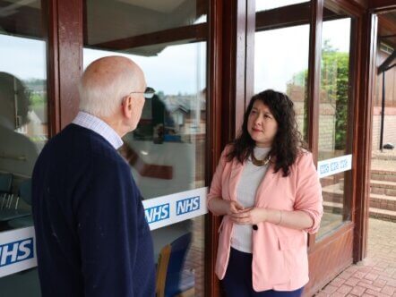 Victoria Collins MP speaking to a constituent outside a GP surgery