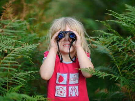 Living Magazines Wildfest Young girl bird watching out on heath Suffolk Sandlings summerYoung girl bird watching out on heath Suffolk Sandlings summer