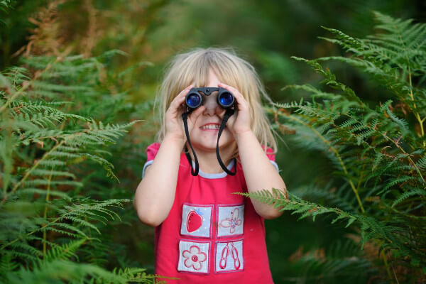 Living Magazines Wildfest Young girl bird watching out on heath Suffolk Sandlings summerYoung girl bird watching out on heath Suffolk Sandlings summer
