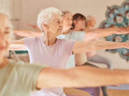 Yoga fitness, class and senior women training for elderly wellness, health and retirement self care in pilates studio. Healthcare, body workout and calm group of people exercise for healthy lifestyle.