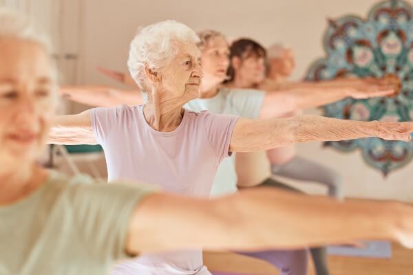 Yoga fitness, class and senior women training for elderly wellness, health and retirement self care in pilates studio. Healthcare, body workout and calm group of people exercise for healthy lifestyle.