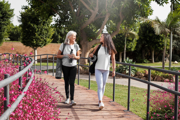 age-difference-female-friends-meeting-up-yoga-outdoors